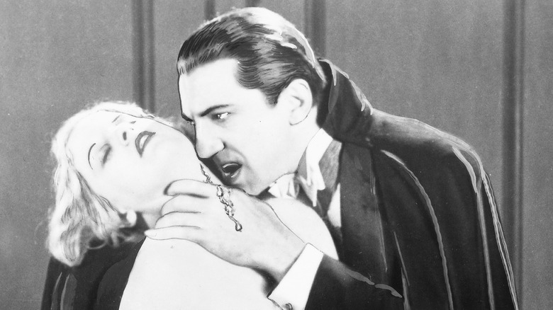Bela Lugosi as Dracula with victim