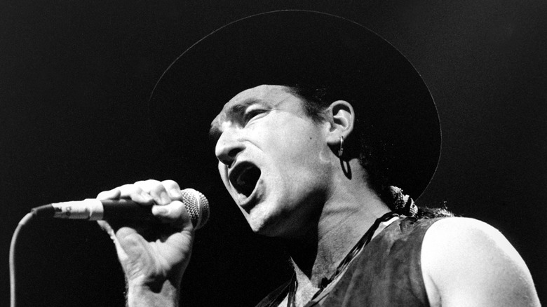 Young Bono cowboy hat microphone