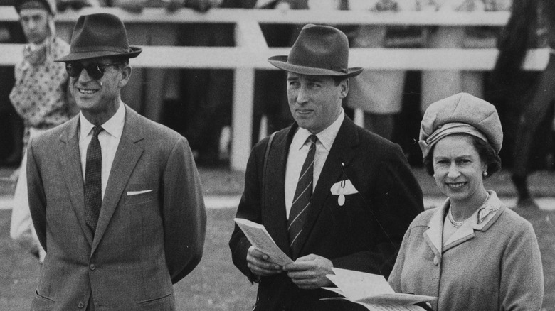 Lord Porchester standing with Queen Elizabeth II