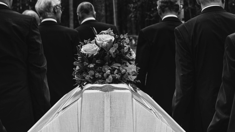 men carrying coffin