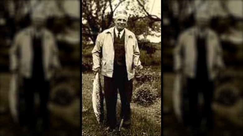 L.L. Bean holding a fish