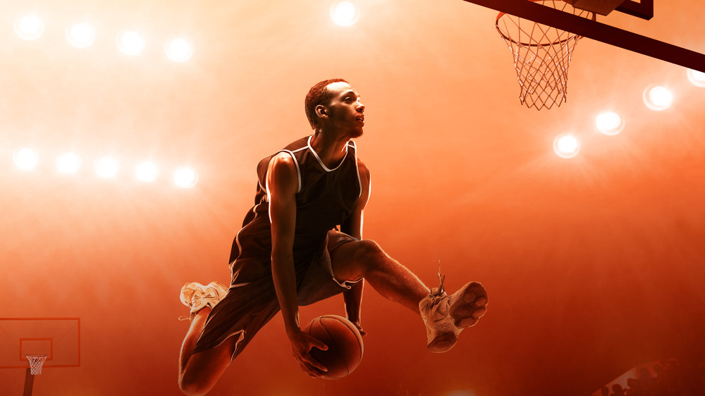 Dunking basketball player