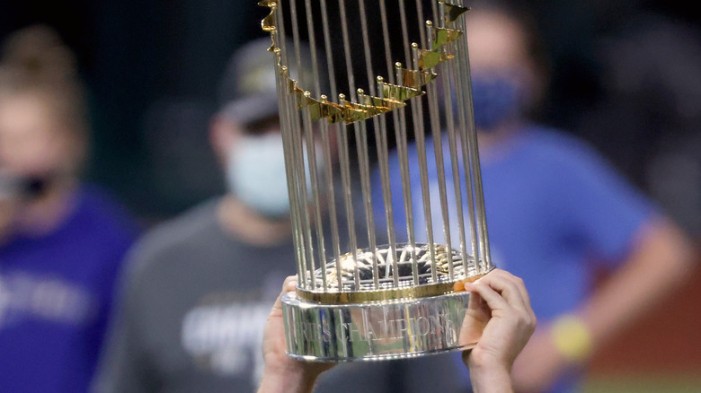 Hands holding World Series Trophy 