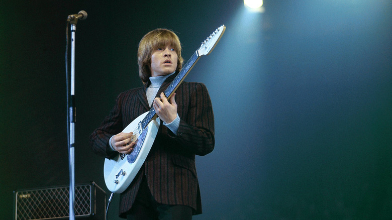 Brian Jones playing guitar onstage