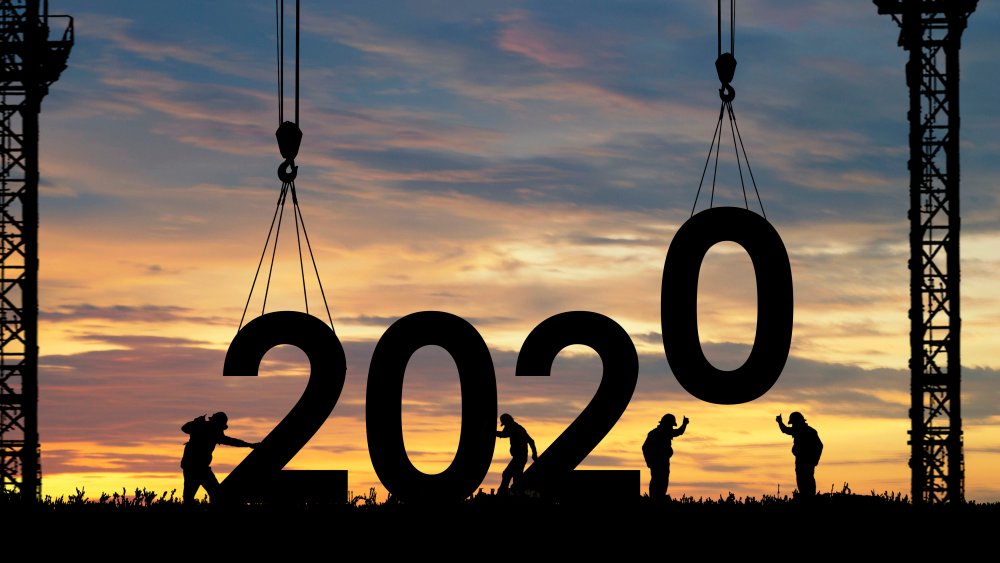 Silhouette staff works as a team to prepare to change sign to 2020
