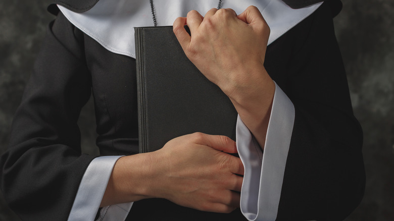 Nun clutching Bible