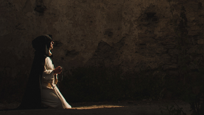 Nun kneeling in prayer