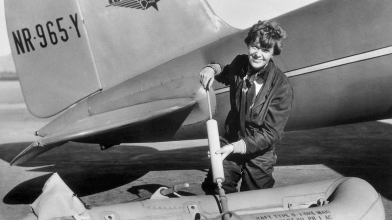 Amelia Earhart demonstrating an inflatable raft from the Electra