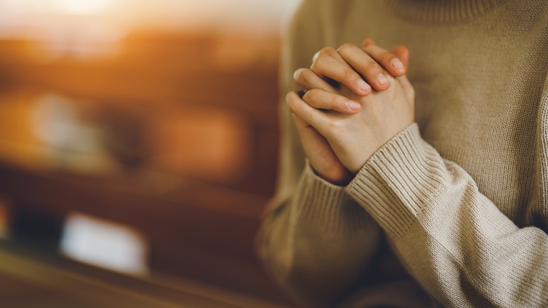 hands clasped in prayer