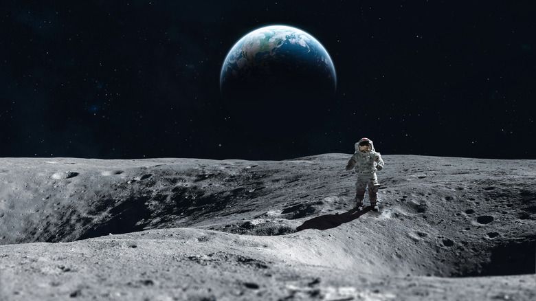 Astronaut on moon with Earth in background