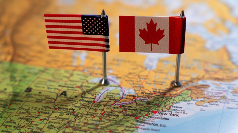 U.S. and Canada flags on map