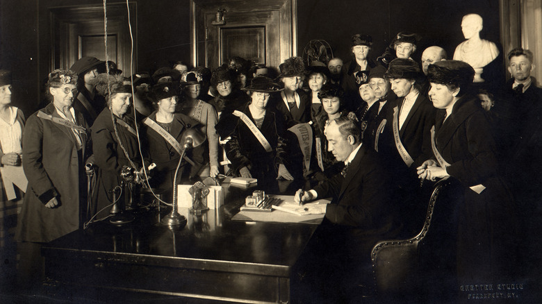 Lots of white women watching the 19th amendment get signed into law