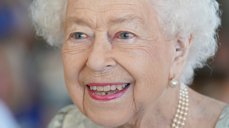 Queen Elizabeth II smiling looking side