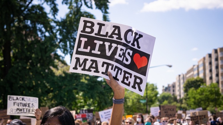 woman holding blm sign