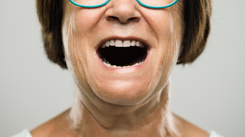 Elderly woman open mouth