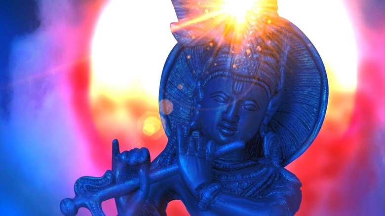 Statue of Krishna against the sun