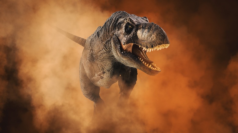 t rex running through dust cloud