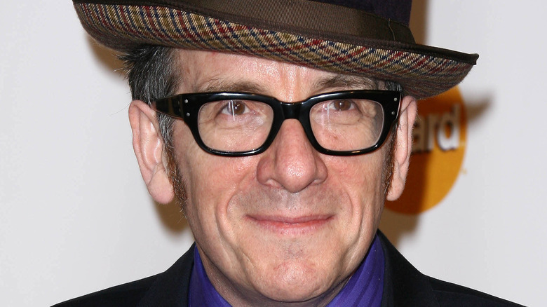 Elvis Costello posing in hat