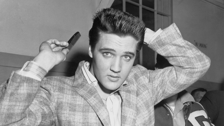 Elvis Presley combing his hair