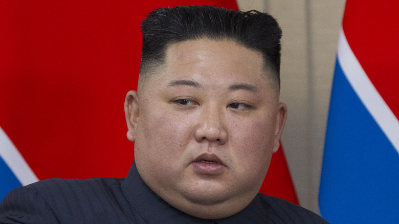 King Jong-un with North Korean flag