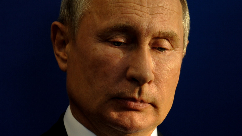 Vladimir Putin looking down and sad