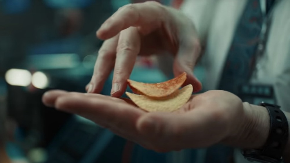 Hands stacking Pringles