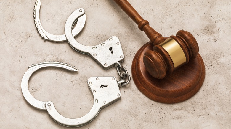 open handcuffs and judge's gavel