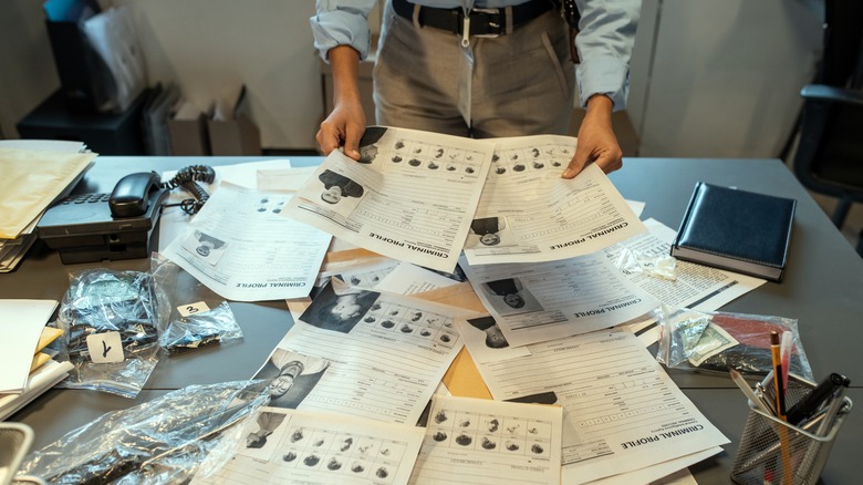 investigator reading suspect files