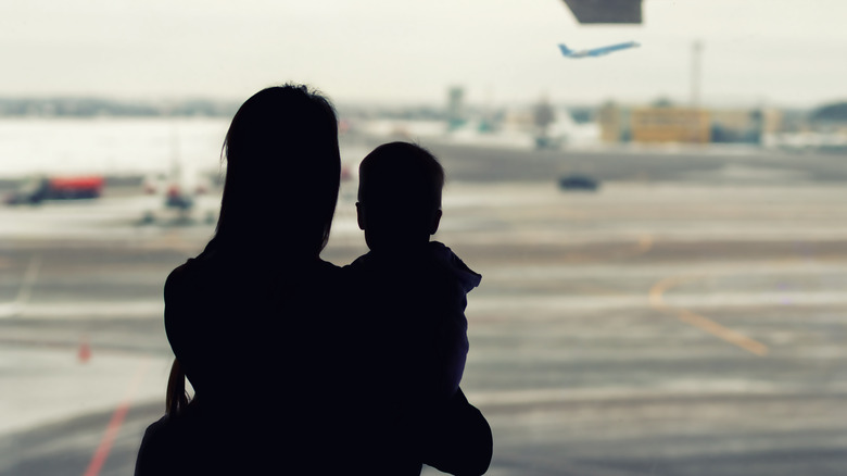 Silhouette mother holding child