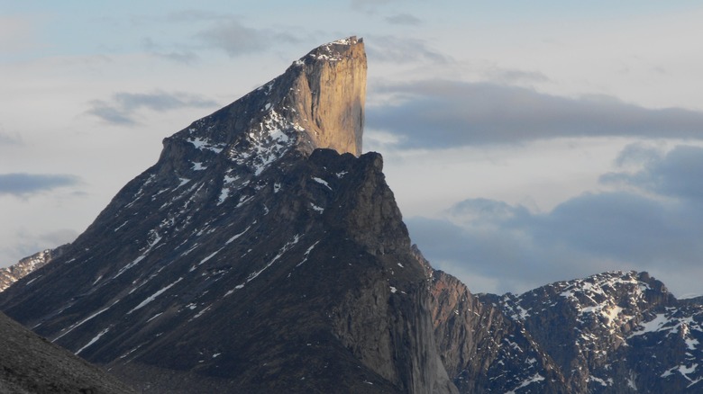 The steep face of Mount Thor against the sky