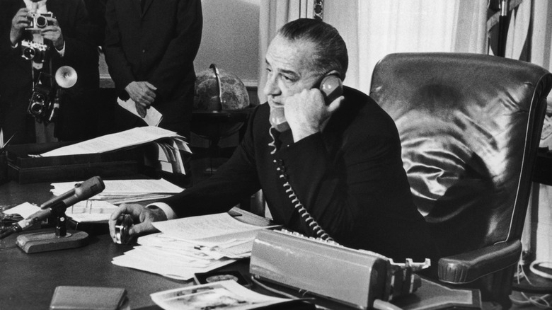 Lyndon Johnson on a phone call at his desk