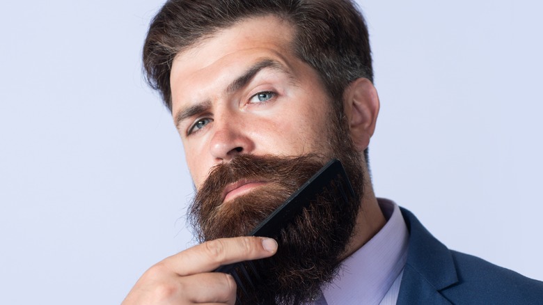 man combing his beard