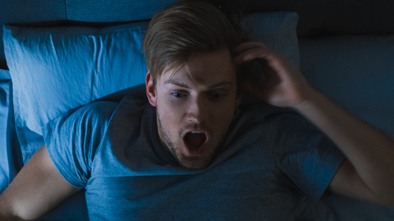 man waking up from nightmare
