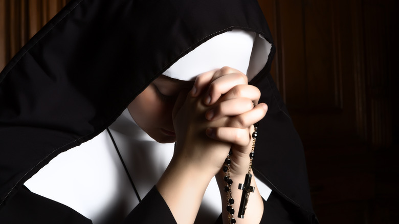Nun praying with bowed head