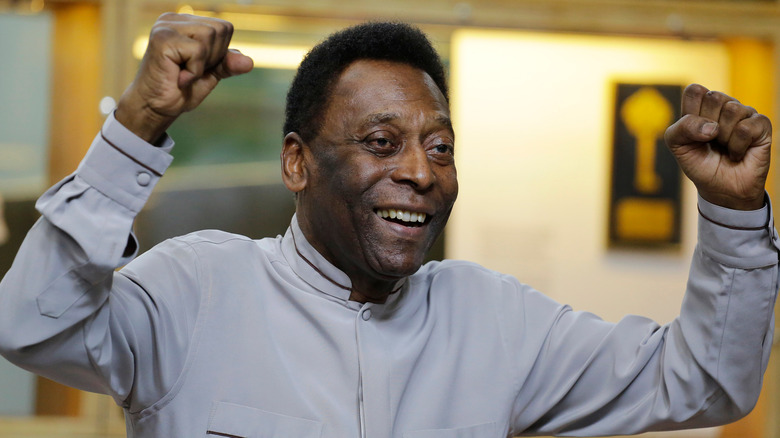 Pelé smiling with arms raised