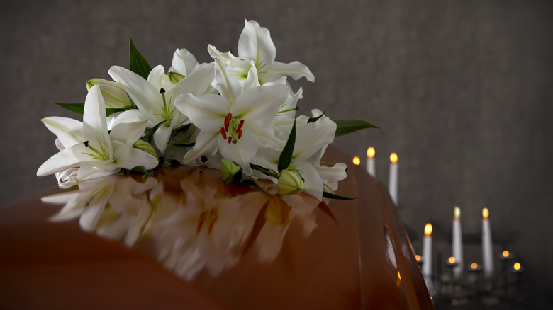 lilies on top of casket