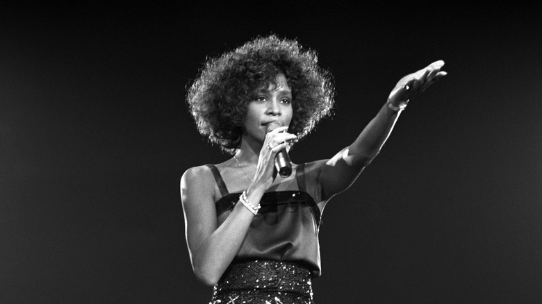 Whitney Houston on stage with microphone