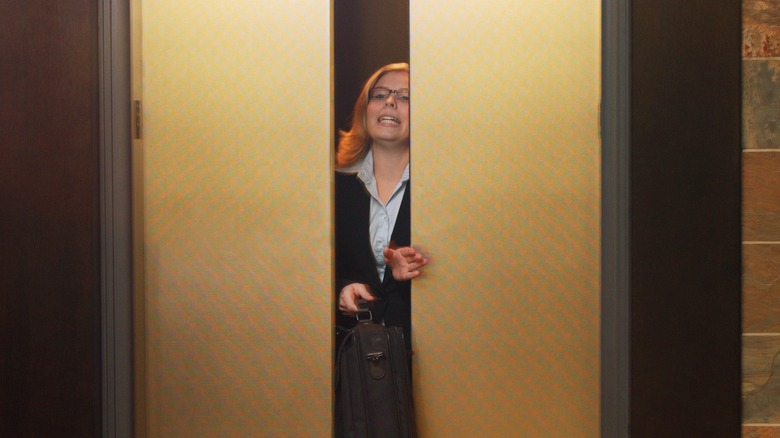Woman leaving elevator door closed