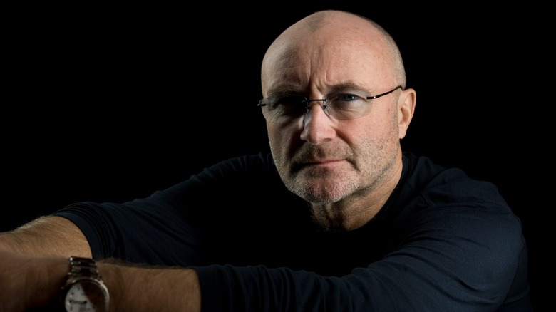 Shadowed Phil Collins frowns