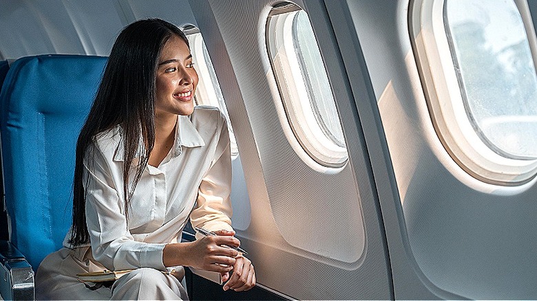 Person looks out plane window