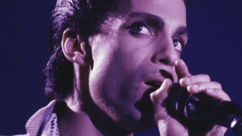 Prince singing into microphone
