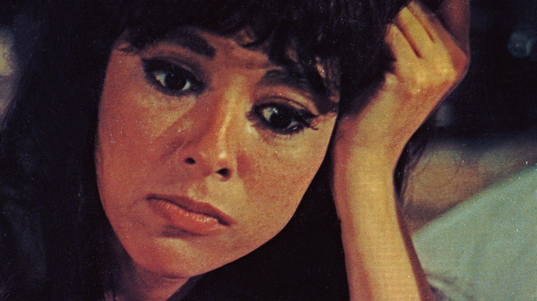 Rita Moreno leans on hand