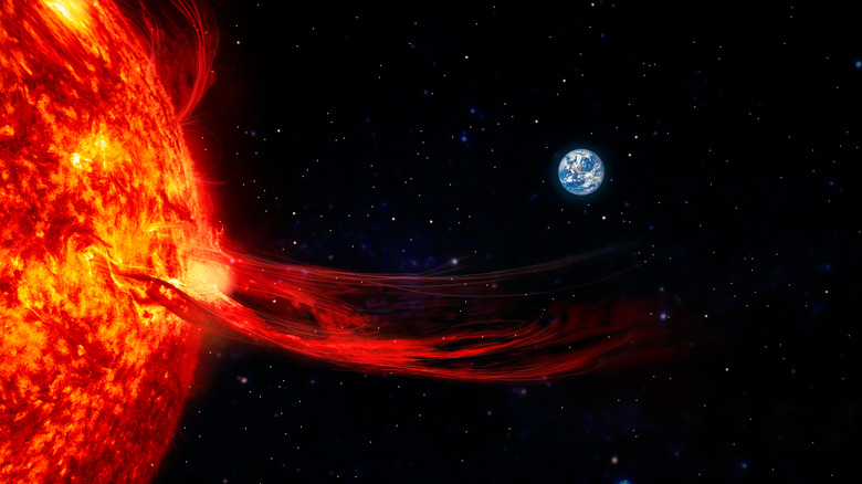 Solar flare with Earth in the background