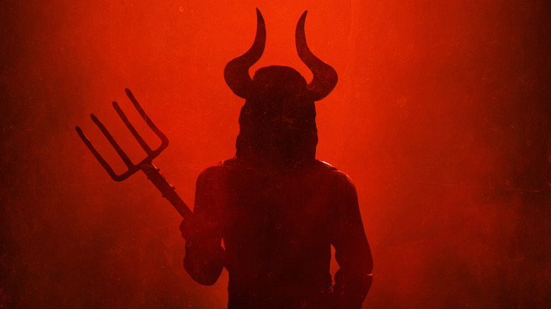 Silhouette of the devil with horns and pitchfork