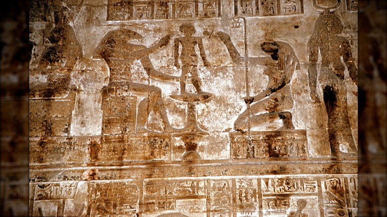 Egyptian gods Khnum and Heket molding human from clay