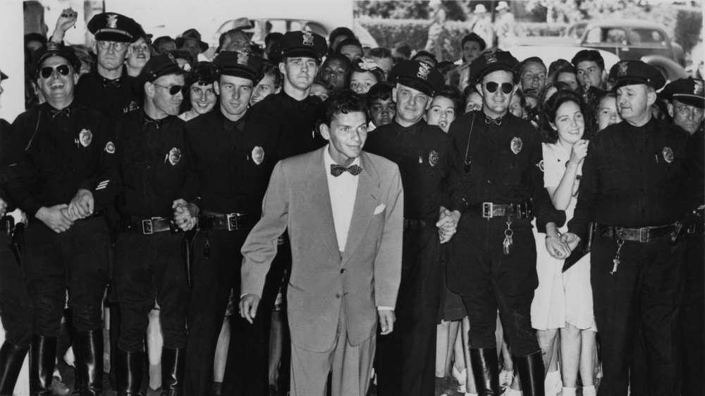 Frank Sinatra surrounded by police