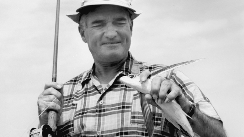 man holding flying fish 