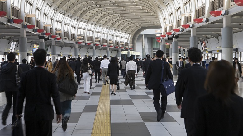 Lots of people walking inside busy building in Tokyo