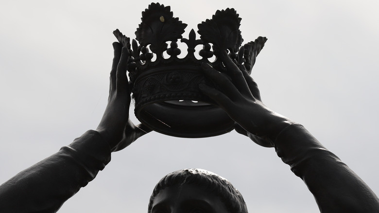 A dark crown lowered on a head