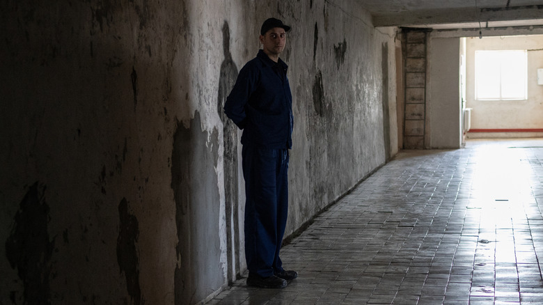 A man standing in a POW camp in Ukraine